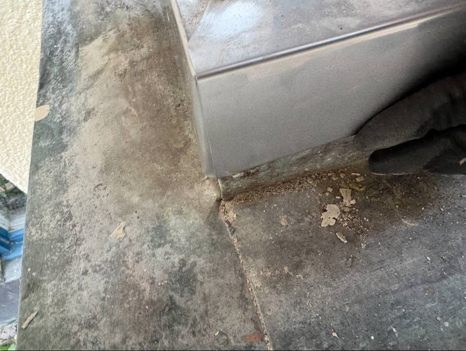Rostfri fotplåt på balkong i Stockholm, installerad för att skydda papptak och förhindra vattenskador.